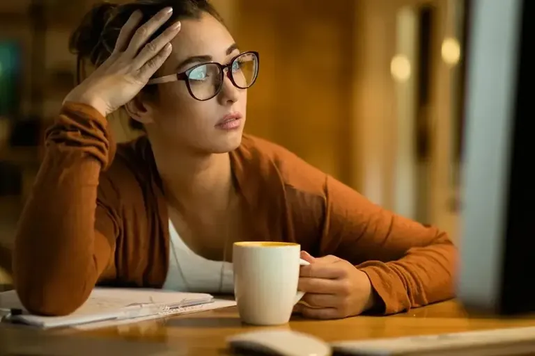 Person sitting quietly, looking worried