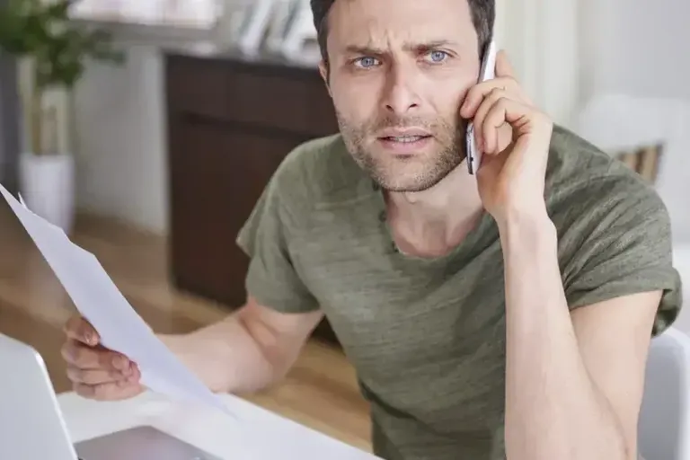 Man on the phone, looking worried
